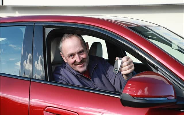 Conor Butler from Waterford shows off the keys to his brand new BMW iX2 which he won in the National Breast Cancer Research Institute (NBCRI) ‘Win A BMW’ raffle. Photo: Sean Lydon