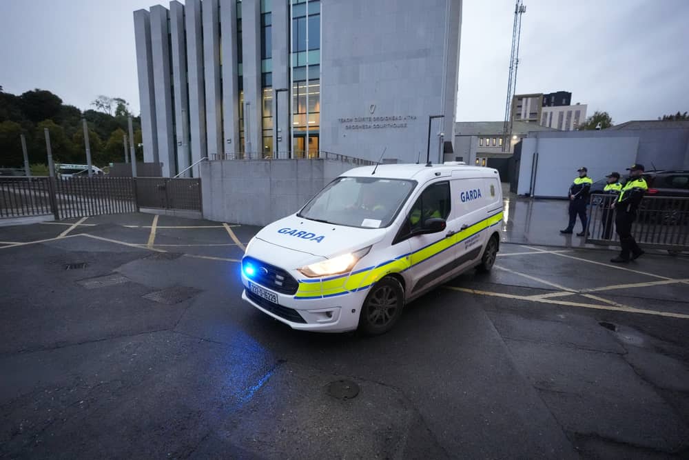 A Garda van leaves Drogheda District Court where a man aged in his 30s has been charged in relation to the deaths of three members of the same family in Co Louth. Pic: Niall Carson/PA Wire