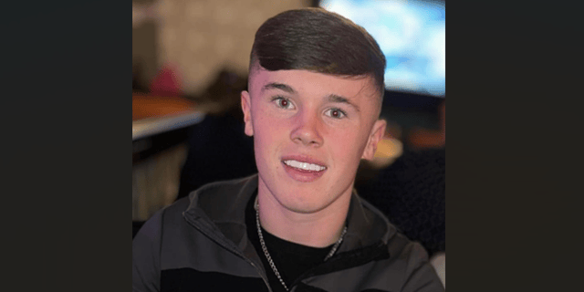 He is described as being approximately 5 foot 7 inches in height, with a slim build, black hair and blue eyes