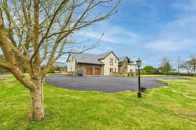 This beautiful five bedroom home has en-suits, walk-in wardrobes and a separate side garage