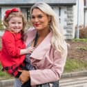 Little Ella in her mum Natalie's arms at the Carndonagh Confirmations in 2023. Photo: Inishowen Independent