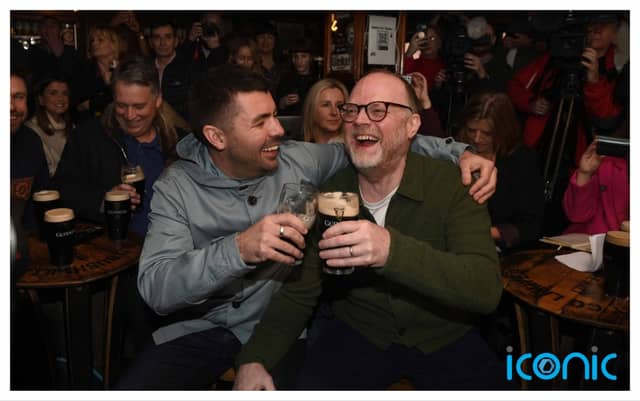Kneecap writer-director Rich Peppiatt (left) and producer Trevor Birney join members of the cast and crew of the movie Kneecap watching a screening of the Oscar nominations at Madden’s Bar in Belfast