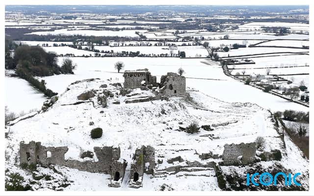 People walk in the snow at the Rock of Dunamase in Co Laois in Ireland