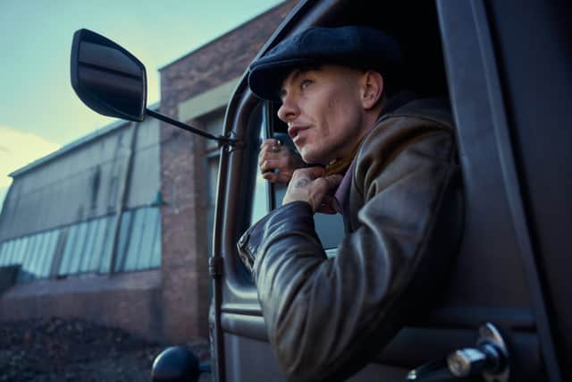 Oscar winner Murphy, 48, is seen as Birmingham gangster Tommy Shelby with a flat cap smiling opposite Keoghan, who is dressed in a grey suit and similar hat.