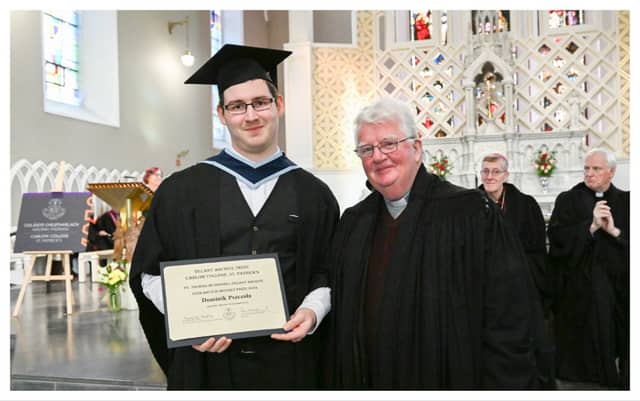 Dominik Pszczola receives his graduation prize from Fr. Frank McEvoy