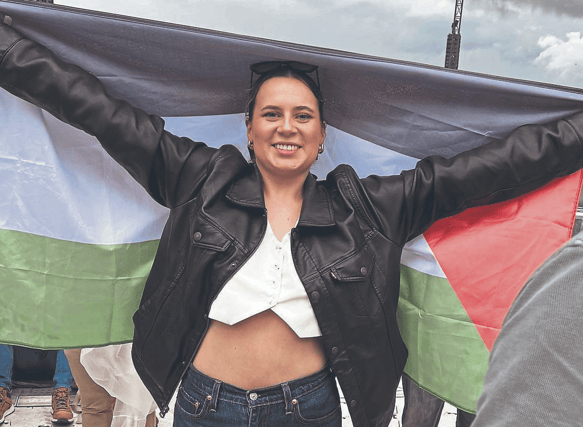 Sophie Cusack Ryan holding a Palestinian flag