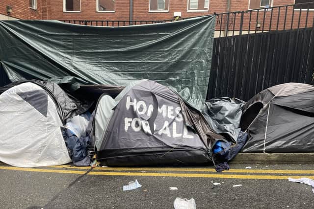 Shoes, cleaning supplies, blankets and other personal belongings were seen in the area after the tents’ removal.