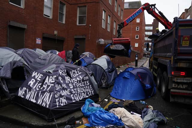 Volunteers who had supplied the men with tents worked to salvage some equipment.