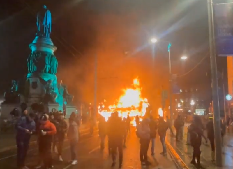 Buses buring in the shadow of the Irish patriot Daniel O'Connell