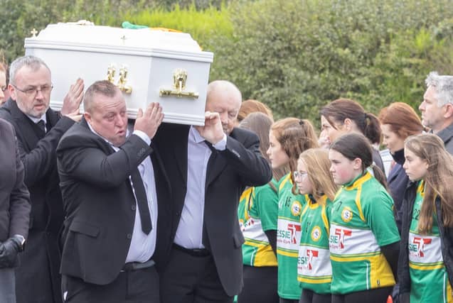 The remains of young Ronan Wilson is carried in St Mary's Church at Dunnamore by family members as it passes a guard of honour by members of the local GAA club. (NW Newspix)