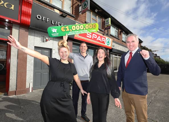 Brian Ferris, owner of the Spar store in St. Agnes Park in Crumlin, Dublin 12 celebrates with staff after his store was announced as the winning location of the €1 million Lotto Plus 1 top prize