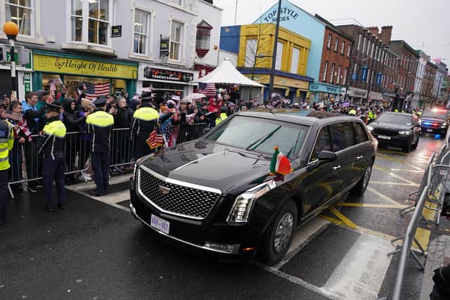 Despite the weather, crowds lined the town’s main street to catch a glimpse of the US leader, who wore a navy baseball cap bearing the American flag as he emerged from The Beast.