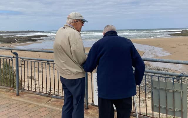 Jim O'Carroll (left) and Seamus O'Rourke looking out to sea, and the spot where the rescue took place