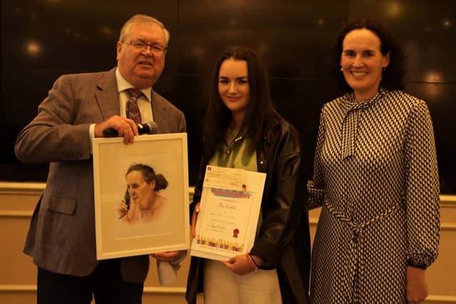Mary Bradfield receives her prizes from Joe Duffy