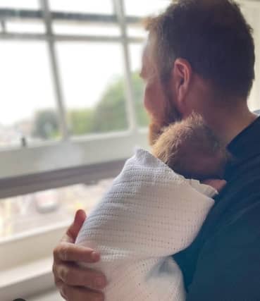Shane holding his newborn baby girl SOURCE: INSTAGRAM