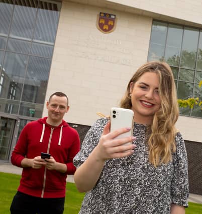 Hannah Murphy and Christopher Parle using the student information app