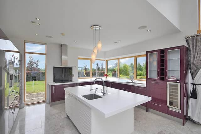 The kitchen area has more than ample units and a large island unit. There is a dual-aspect family room with French doors opening to the garden. This room also features a patio door which opens to one of many large patio areas, and 2 French doors which open to the main living space. There is a study with a large corner window and door opening to a patio area.