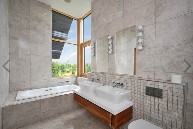 This leads to an impressive, triple-aspect, master bedroom. This bedroom is further enhanced by having a fully-tiled en-suite bathroom with both shower and bath, and a generous walk-in wardrobe. There are three other bedrooms at this level, all of which feature wooden flooring and built-in wardrobes. One of these bedrooms also has a fully-tiled en-suite bathroom. There is also a fully-tiled family bathroom at this level.