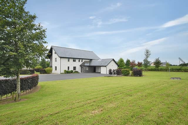 This home benefits from numerous unique features, such as underfloor heating downstairs, an integrated vacuum system, both internal and external sound systems, secure electric gates, a carport with storage rooms, electric skylights and blinds, and rooms wired for both TV and WiFi.