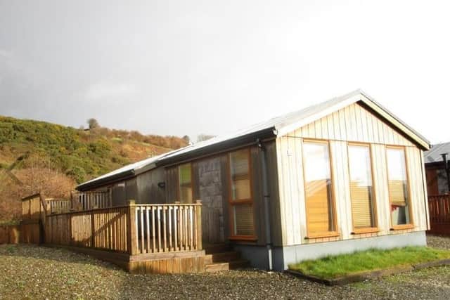 This stylish 3-bedroom Scandanavian log cabin set in a popular shoreside holiday park in Donegal is on the market for a budget-friendly price.