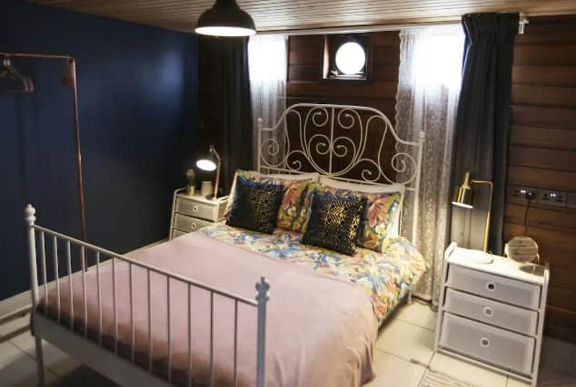 The beautifully-decorated cabin bedroom has a double bed and lots of storage, featuring all the home comforts you could wish for.
