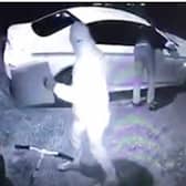CCTV showing two men stealing a car using keyless fob tools