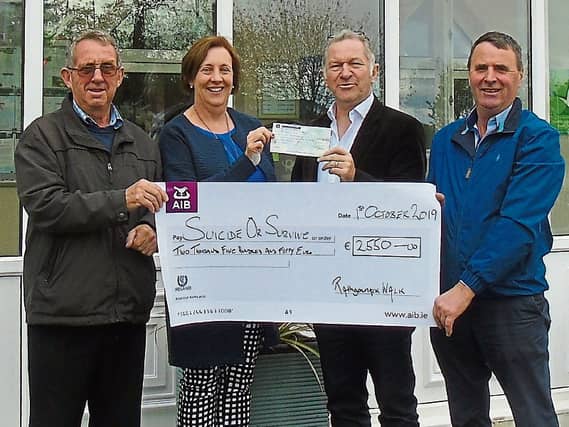 John Larkin and Martina Walsh from Rathgormack presenting the sponsored walk/run proceeds cheque to Robery Carley of the Suicide or Survive charity with Cllr Liam Brazil