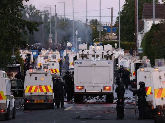 Police block a road to protesters