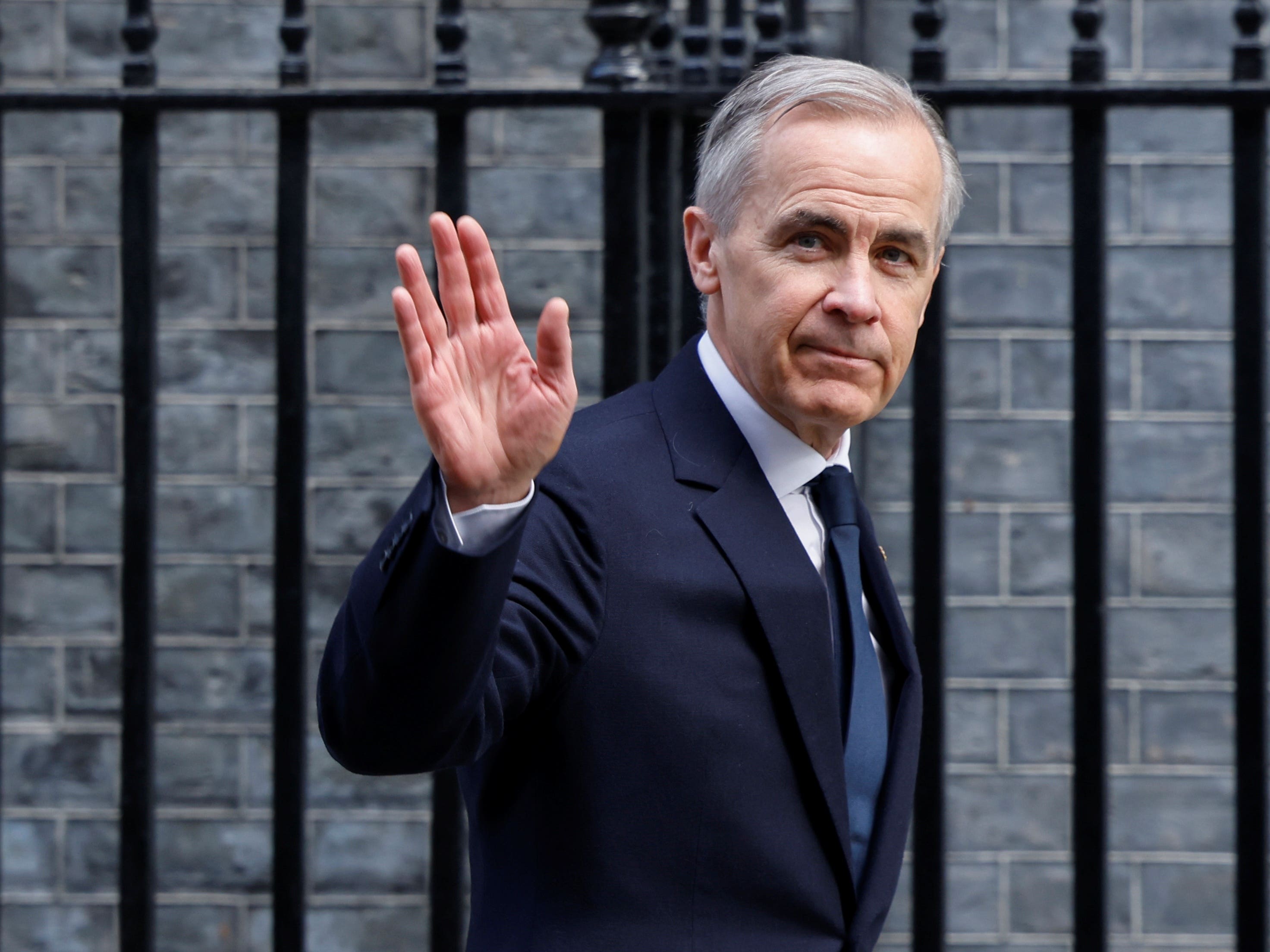 Mark Carney walks down Downing Street in London