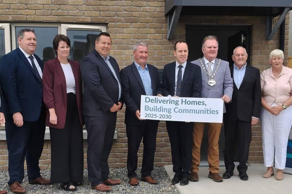 Minister Cummins alongside various public representatives and officials at the Abbeymount development