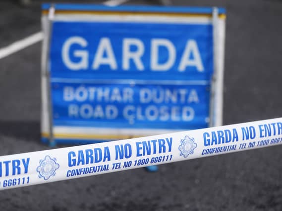 Garda tape and road closed sign