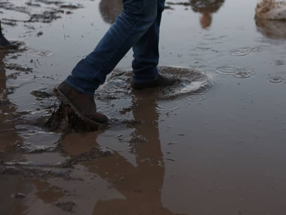 A person steps in flood water