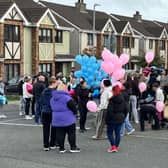 People gather ahead of a balloon release ceremony in Birchwood on Wednesday