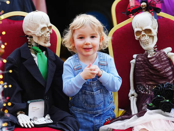Two-year-old Luca Patterson with two toy skeltons